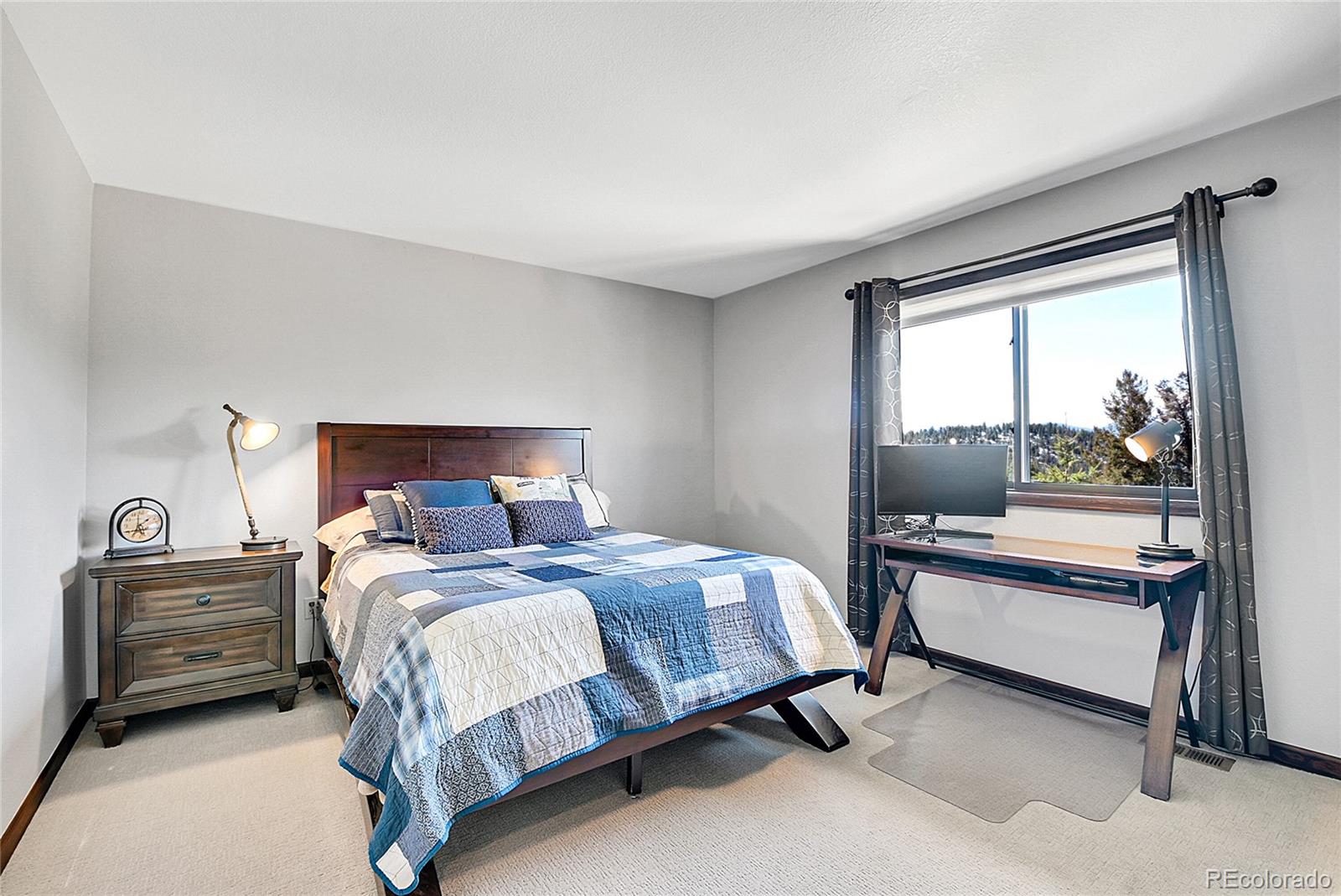 1567 Tapadero Road Bailey, CO 80421 - Photo 14 of 26 a bedroom with a bed and a window