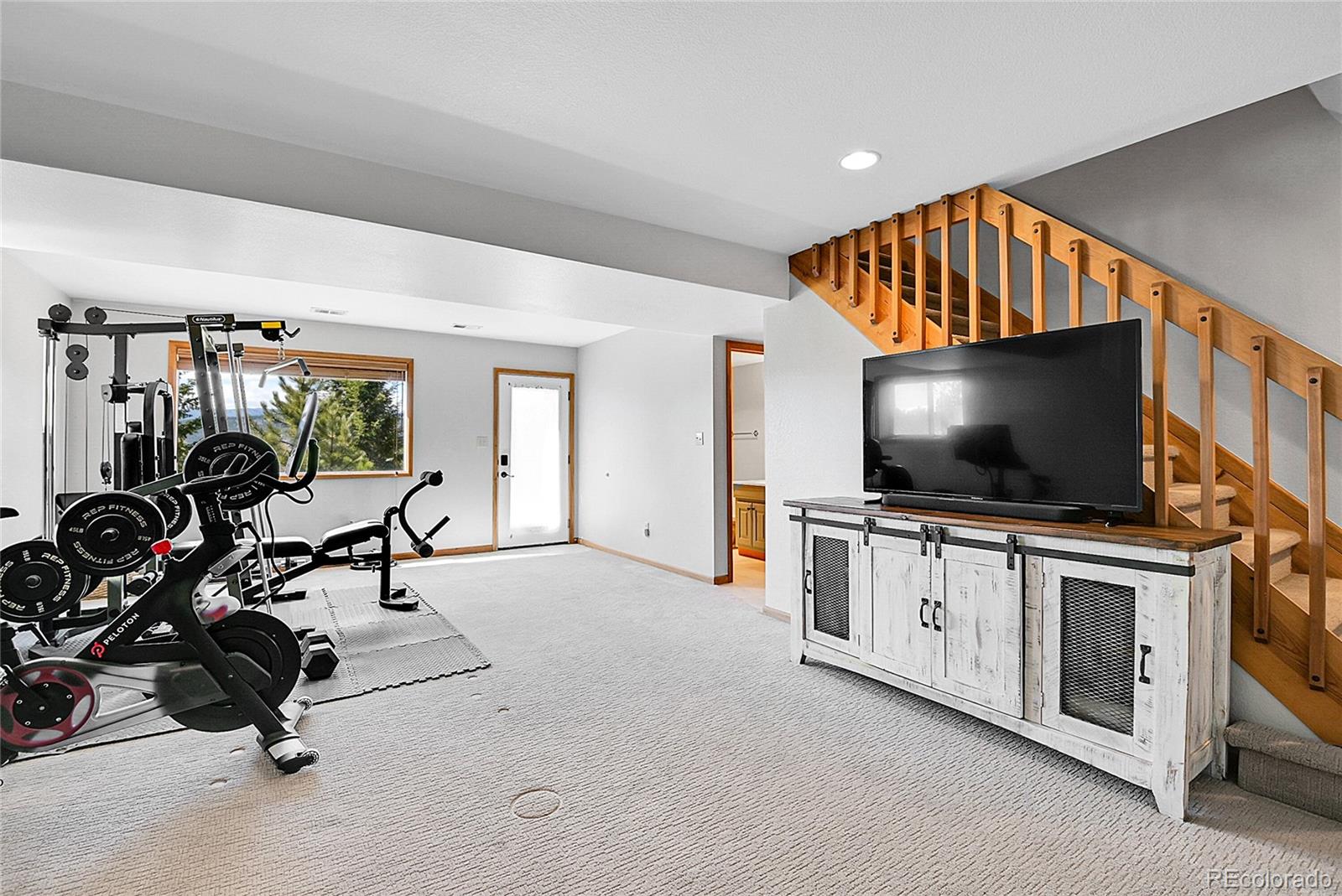 1567 Tapadero Road Bailey, CO 80421 - Photo 18 of 26 a view of a livingroom with furniture and a flat screen tv