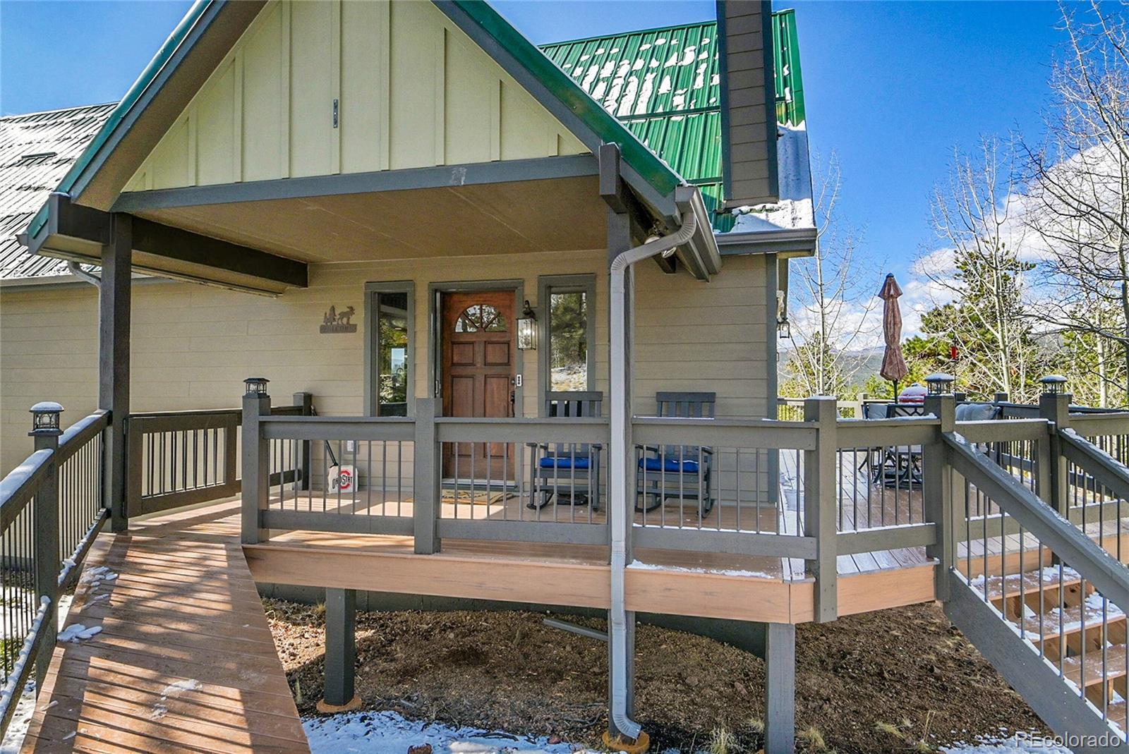 1567 Tapadero Road Bailey, CO 80421 - Photo 26 of 26 a view of house with wooden deck and outdoor seating