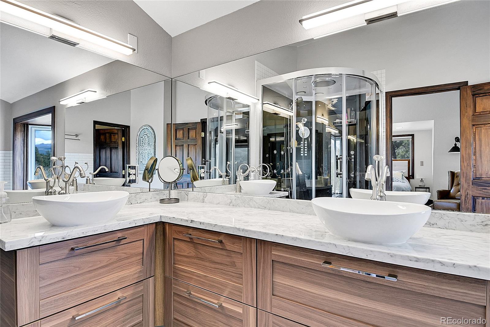 1567 Tapadero Road Bailey, CO 80421 - Photo 8 of 26 a bathroom with a granite countertop sink mirror and vanity