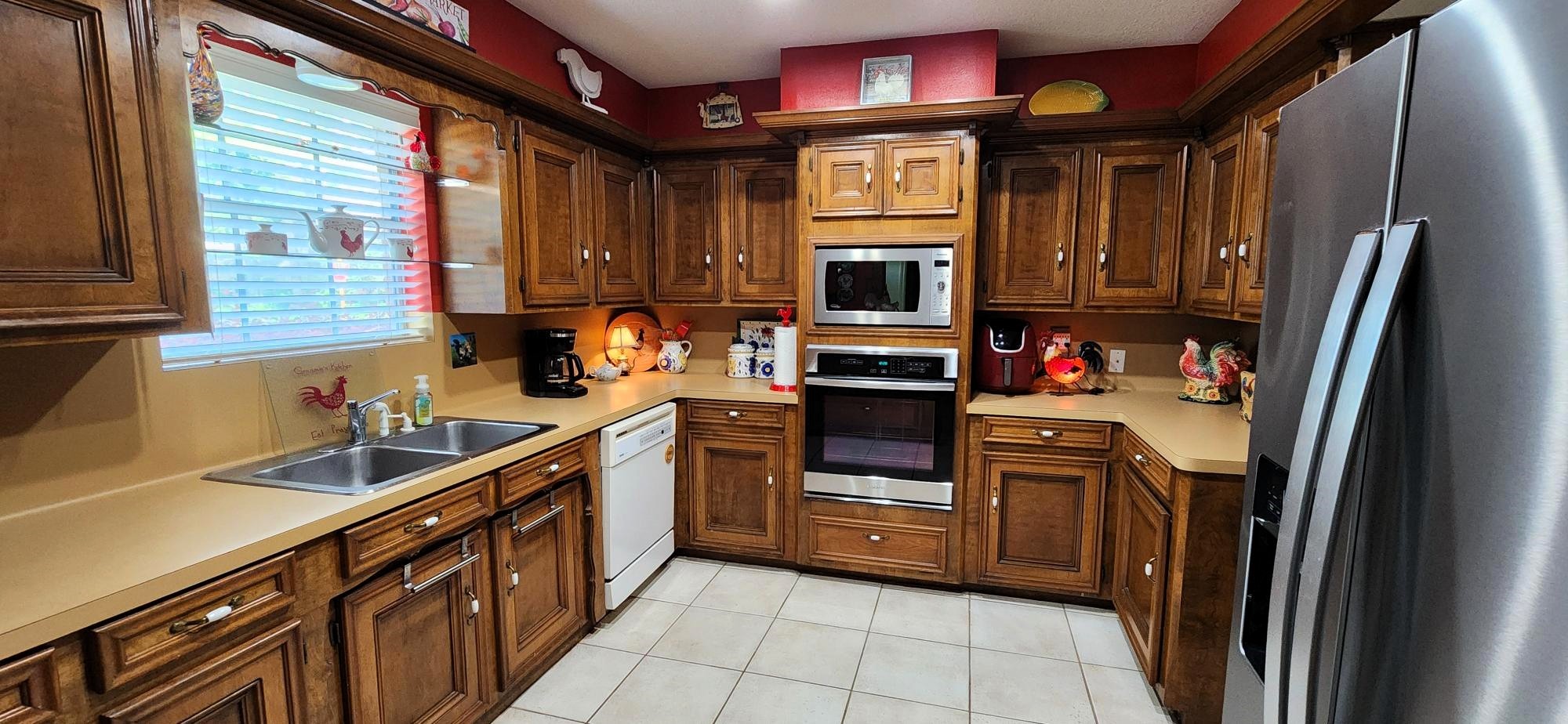 16155 Hexham Drive Spring, TX 77379 - Photo 15 of 47 a kitchen with stainless steel appliances a stove a sink and a refrigerator