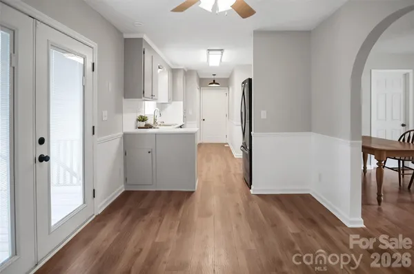 a kitchen with wooden floor and window