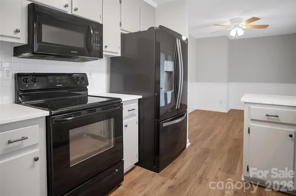 a kitchen with stainless steel appliances a stove microwave and refrigerator