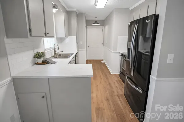 a kitchen with stainless steel appliances a refrigerator sink and stove