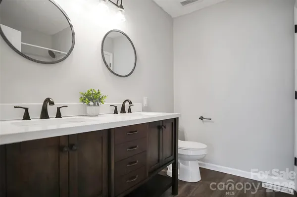 a bathroom with a toilet a sink and a mirror