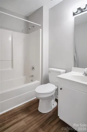 a bathroom with a toilet a sink and bathtub