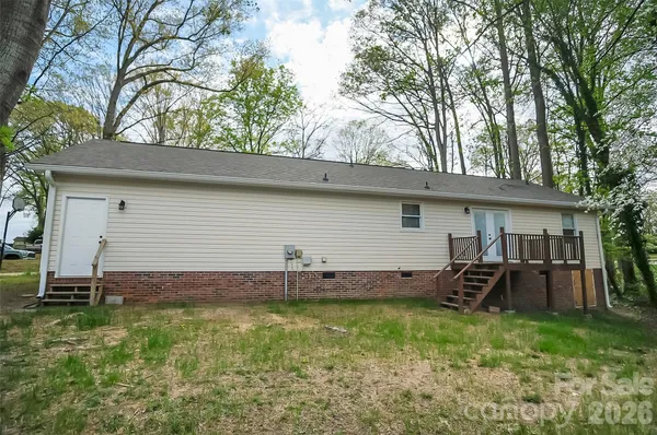 a backyard of a house with barbeque oven table and chairs