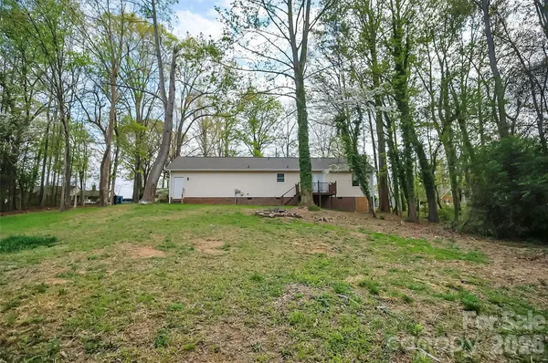 a view of a backyard with large trees