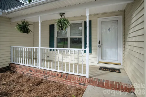a view of a house with a small yard and wooden floor and fence
