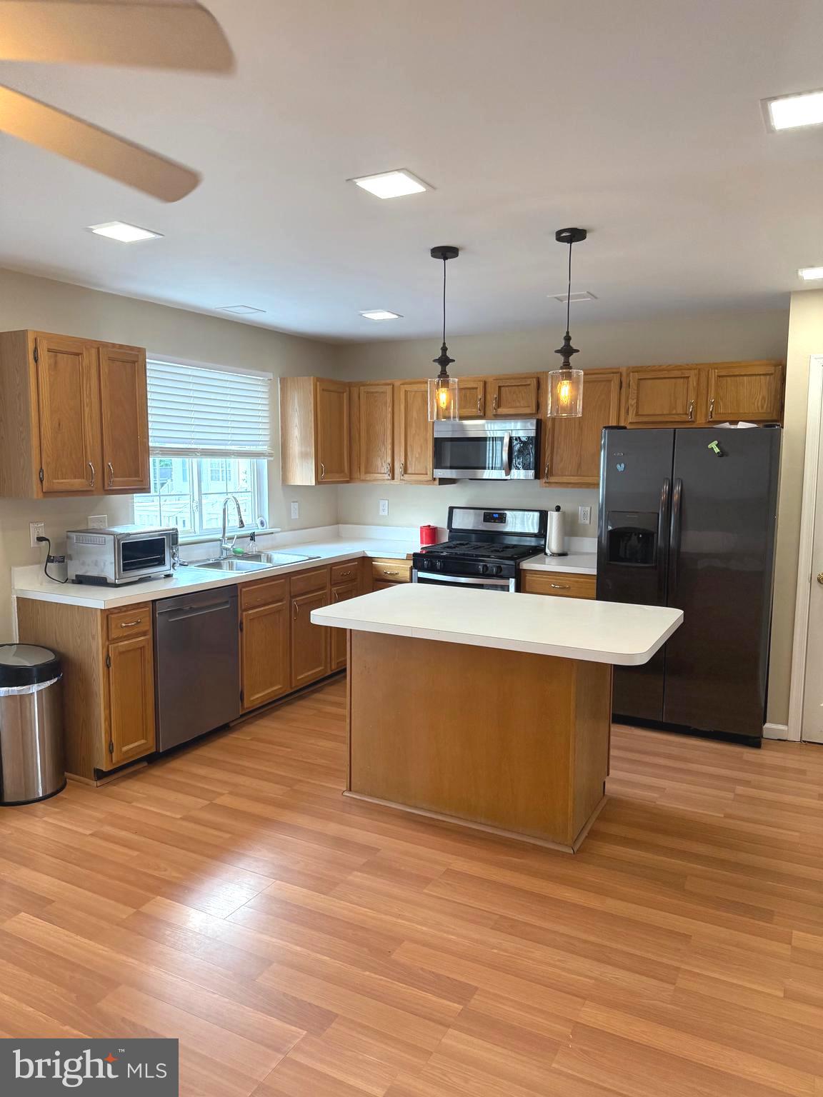 19 Spring Drive Newark, DE 19702 - Photo 14 of 47 a kitchen with stainless steel appliances a sink a stove a refrigerator cabinets and wooden floor