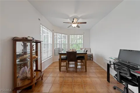 a view of a dining room with furniture and a window