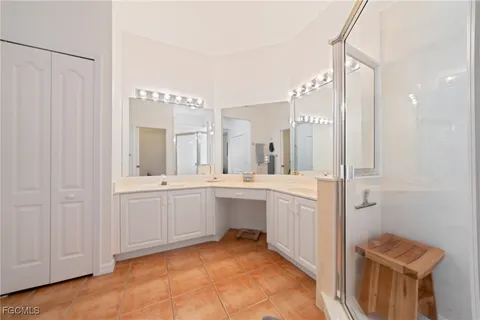 a spacious bathroom with a double vanity sink a mirror and a bathtub