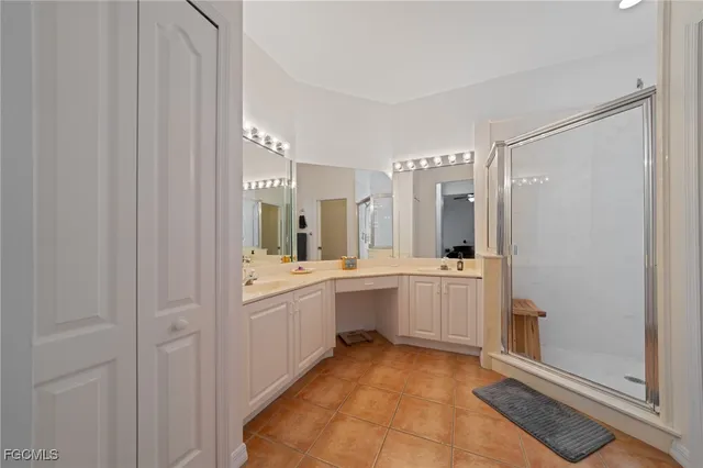 a large bathroom with a double vanity sink and mirror