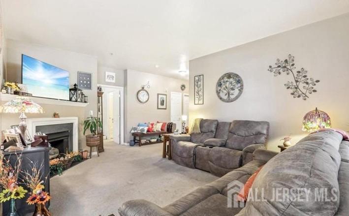 110 Kyle Way Ewing, NJ 08628 - Photo 6 of 39 a living room with furniture a fireplace and a flat screen tv