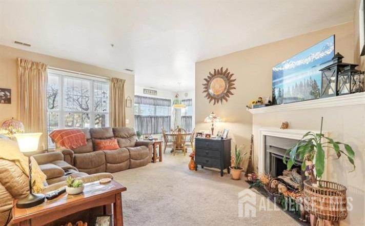 110 Kyle Way Ewing, NJ 08628 - Photo 8 of 39 a living room with furniture a fireplace and a floor to ceiling window