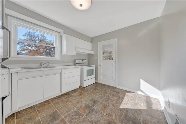 a spacious bathroom with a sink and a mirror