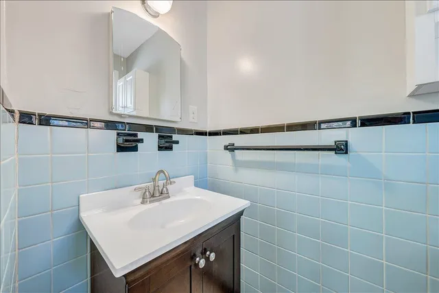 a bathroom with a sink a mirror and shower