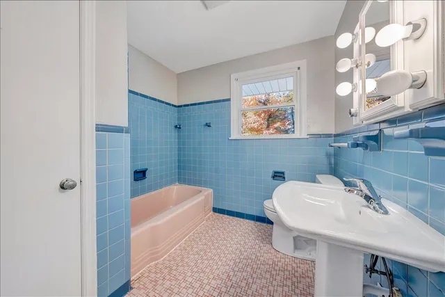 a bathroom with a sink a toilet and bathtub