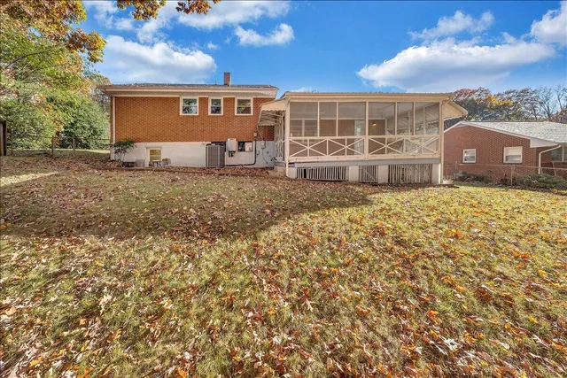 a view of a house with backyard and a tree