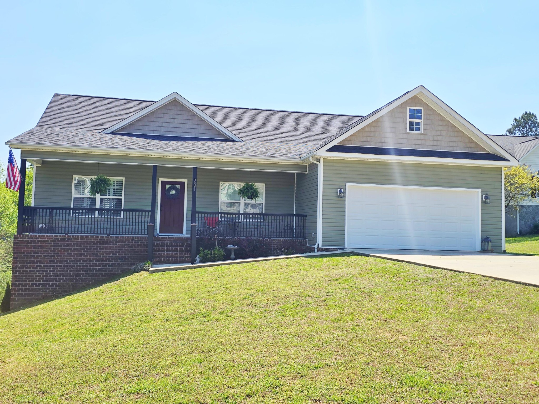 231 Clara Lane Dayton, TN 37321 - Photo 1 of 17 a front view of a house with a yard and garage