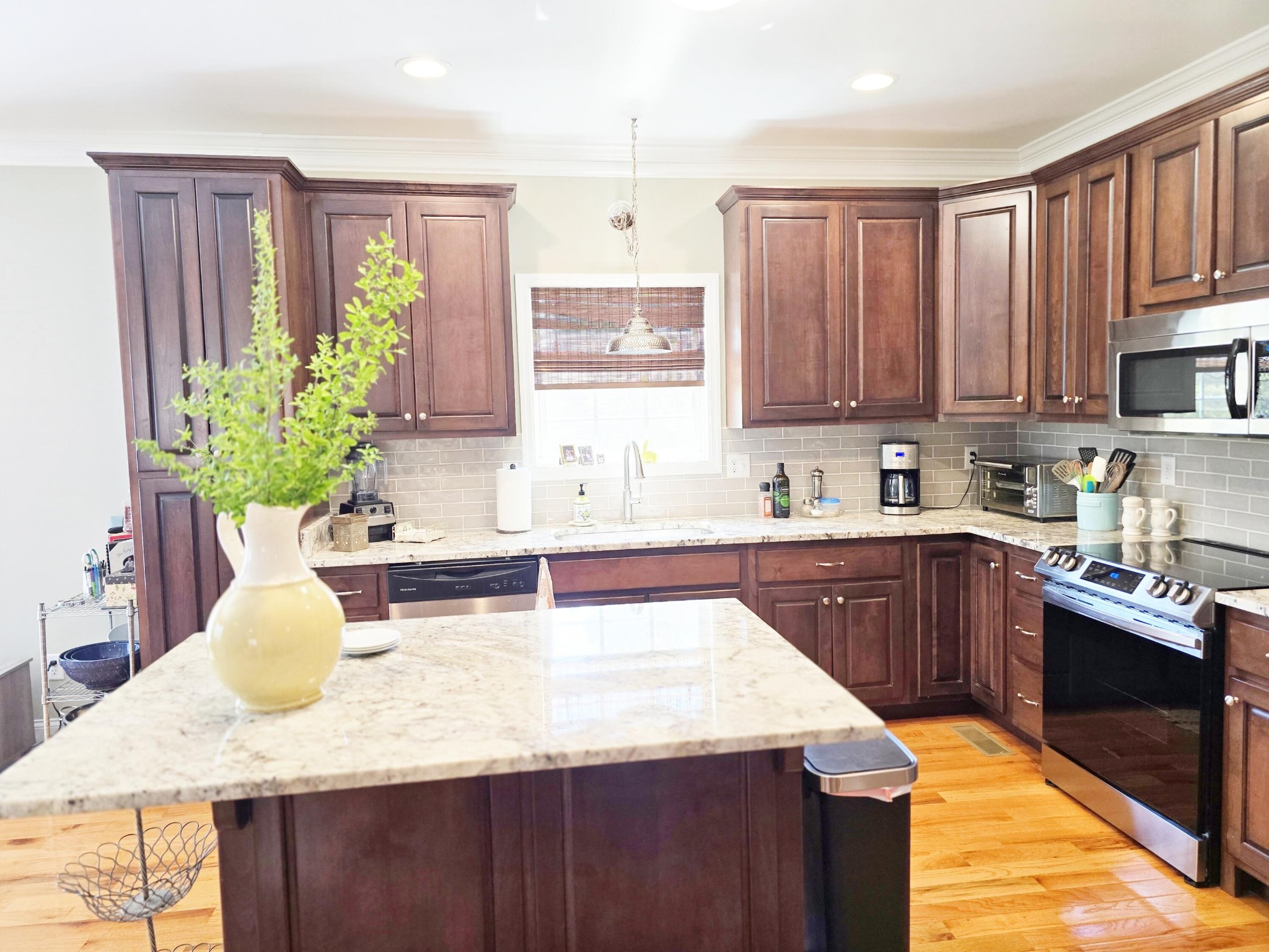 231 Clara Lane Dayton, TN 37321 - Photo 7 of 17 a kitchen with kitchen island granite countertop a sink a stove and cabinets
