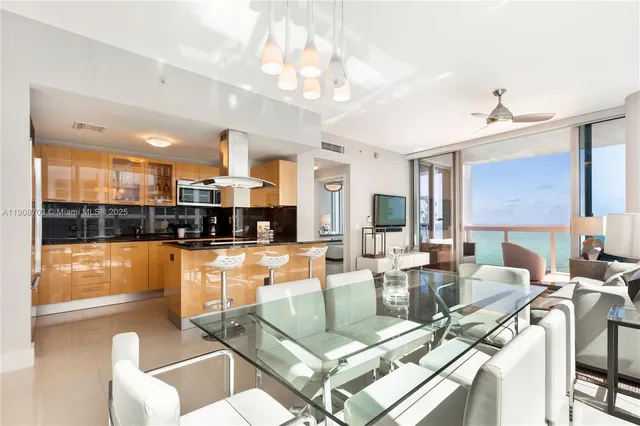 a living room with fireplace furniture and a large window