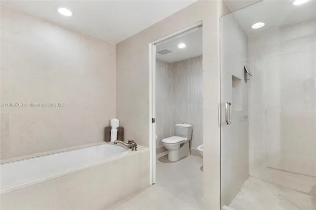 a bathroom with a bathtub and a toilet