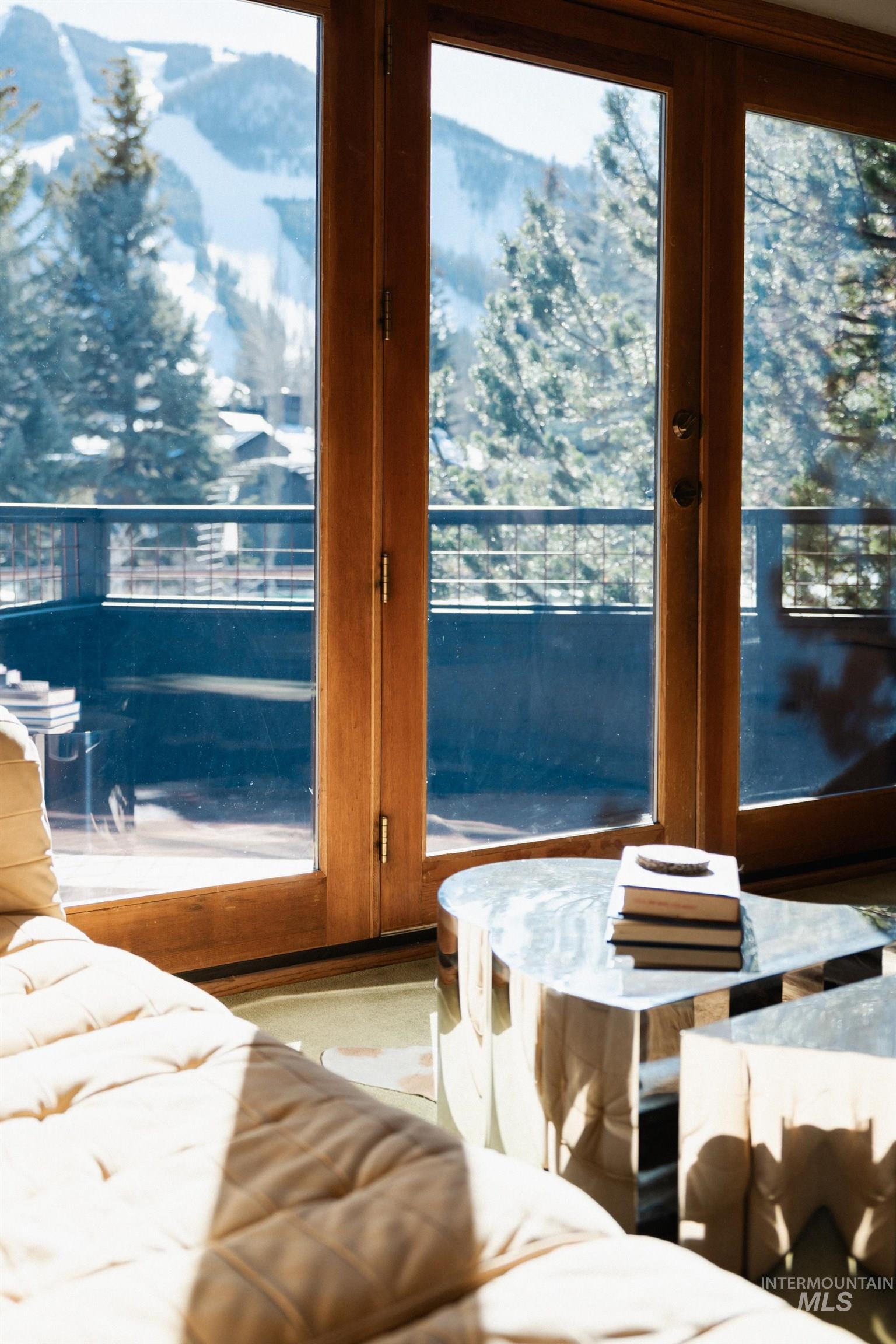 208 Georginia Road, Unit A Ketchum, ID 83340 - Photo 5 of 30 Wood-framed glass doors, cable railing balcony, and mountain scenery