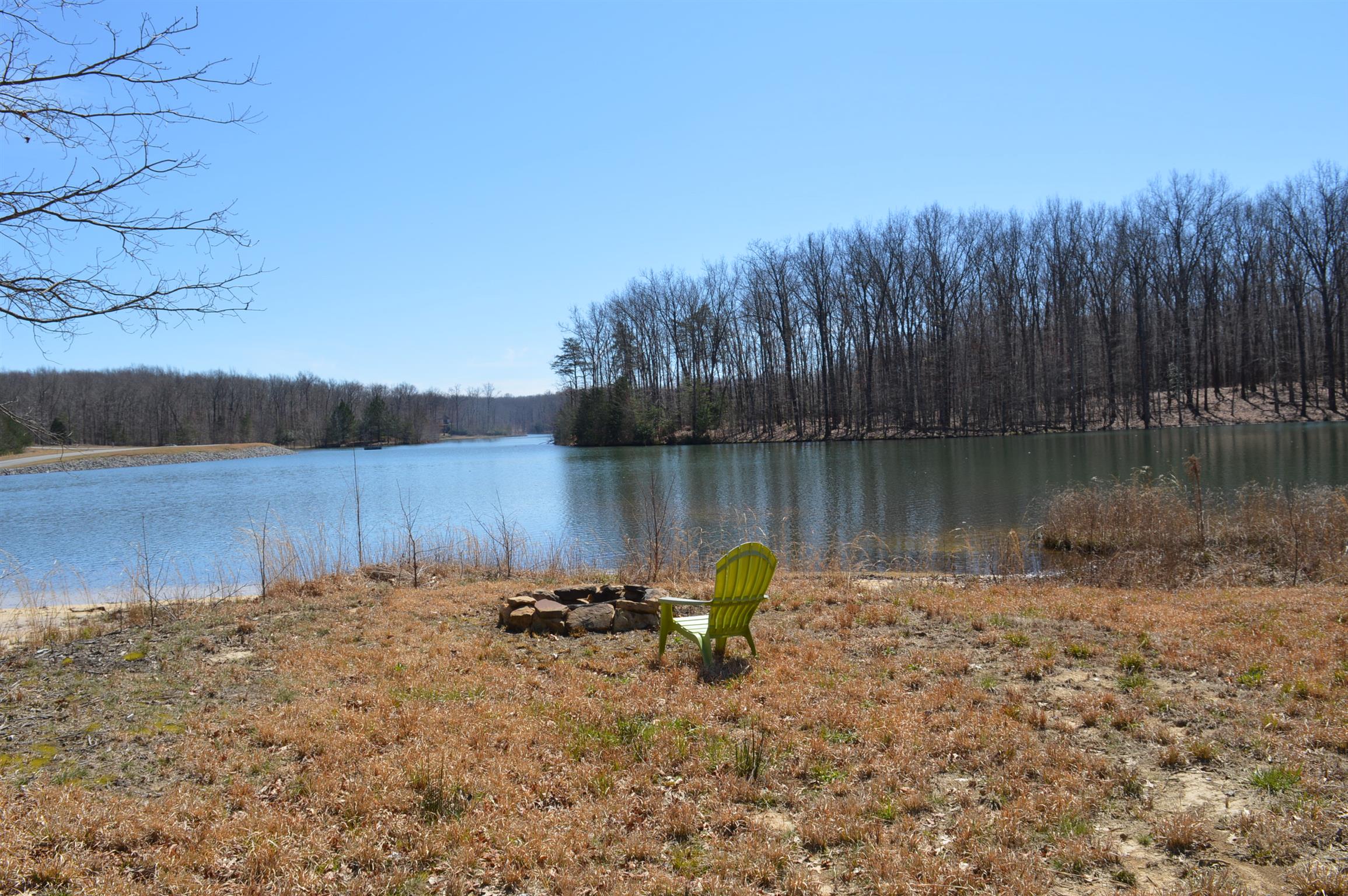 1175 Cooley's Rift Boulevard Monteagle, TN 37356 - Photo 22 of 27 a view of a lake with a bench in the background