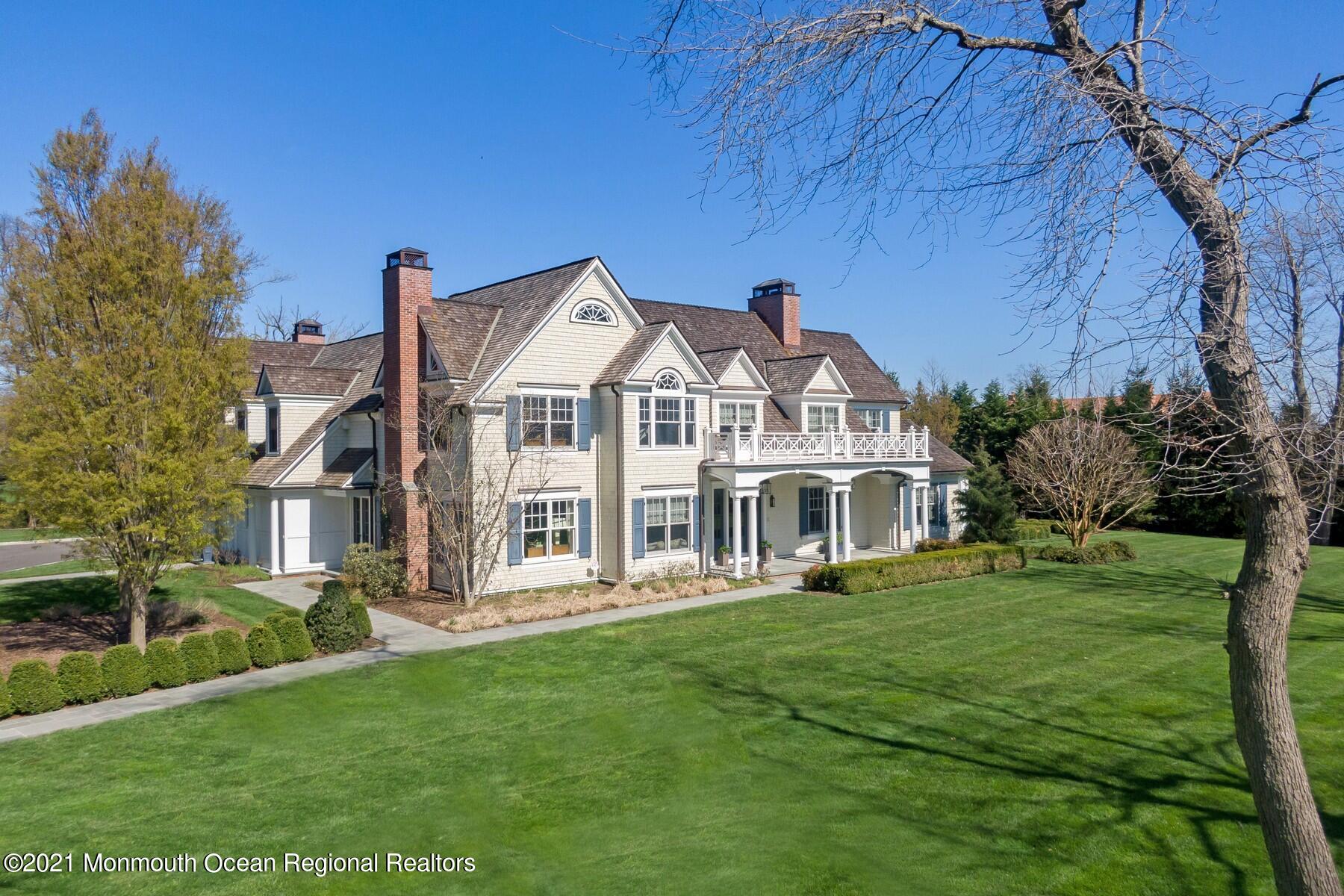 21 Conover Lane Rumson, NJ 07760 - Photo 2 of 40 a front view of a house with a garden