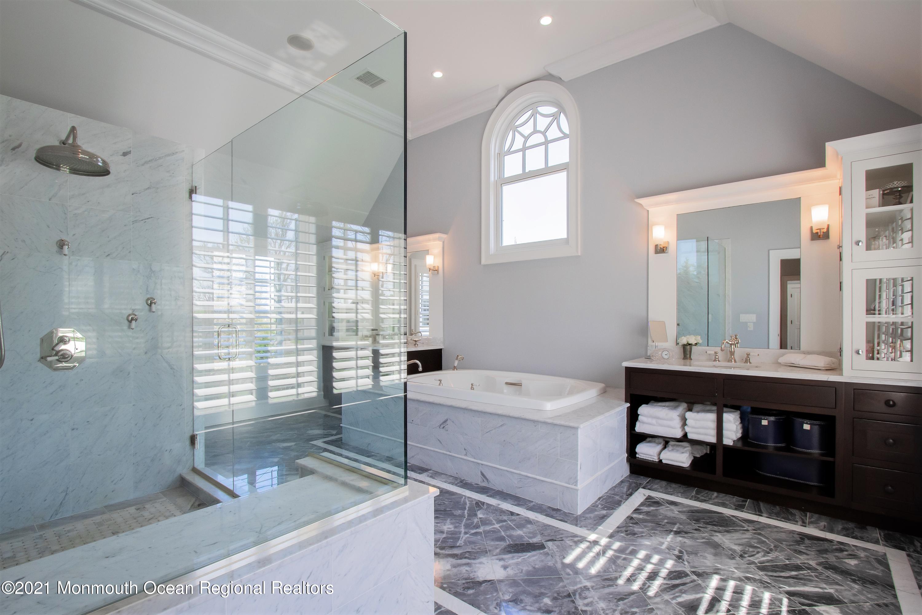 21 Conover Lane Rumson, NJ 07760 - Photo 29 of 40 a spacious bathroom with a double vanity sink a mirror and a bathtub