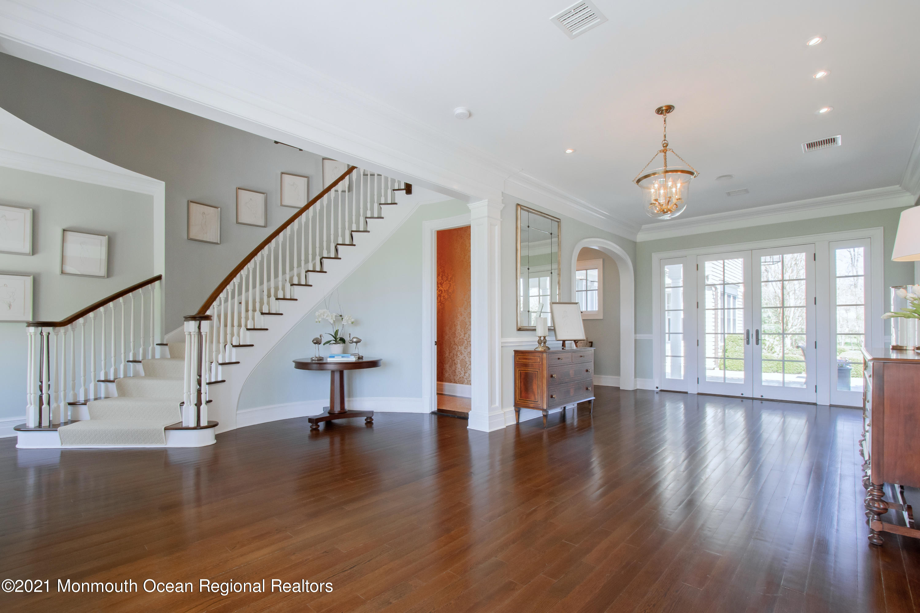 21 Conover Lane Rumson, NJ 07760 - Photo 4 of 40 a view of an entryway with wooden floors fireplace and windows