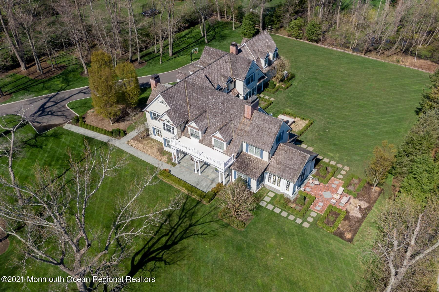 21 Conover Lane Rumson, NJ 07760 - Photo 37 of 40 an aerial view of a house with a garden and lake view