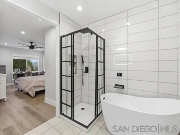 a bathroom with a bathtub and a shower