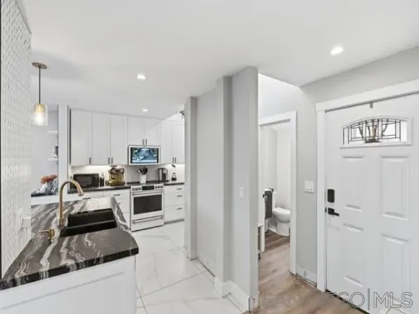 a kitchen with refrigerator and cabinets