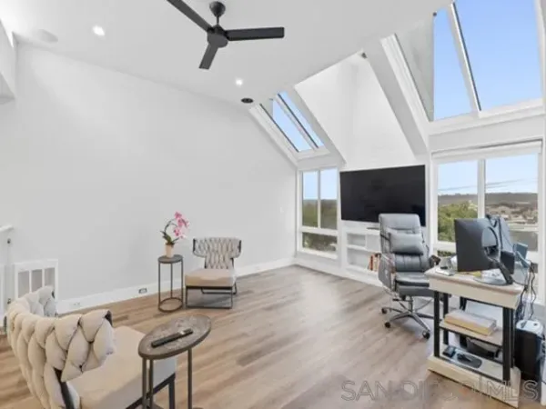 a work room with furniture and a flat screen tv