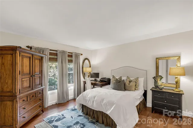 a bedroom with a bed dresser and a window