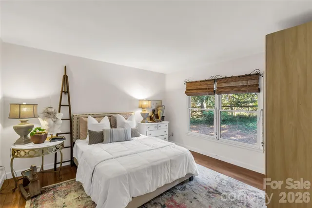 a bedroom with a large bed and a window