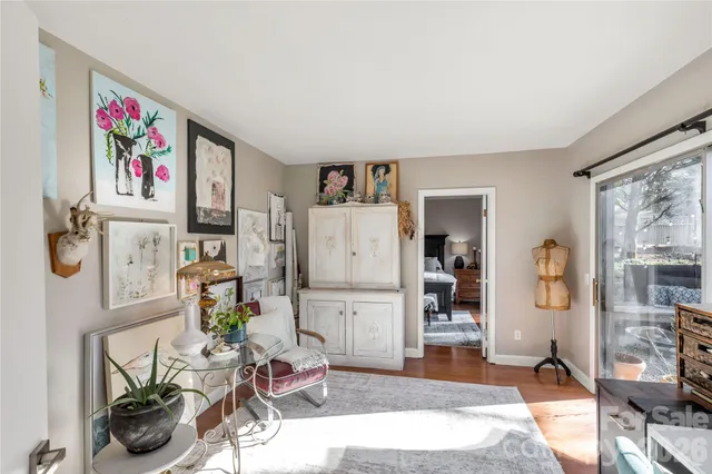 a living room with furniture and a refrigerator