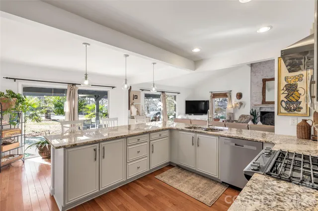 a large white kitchen with a large window