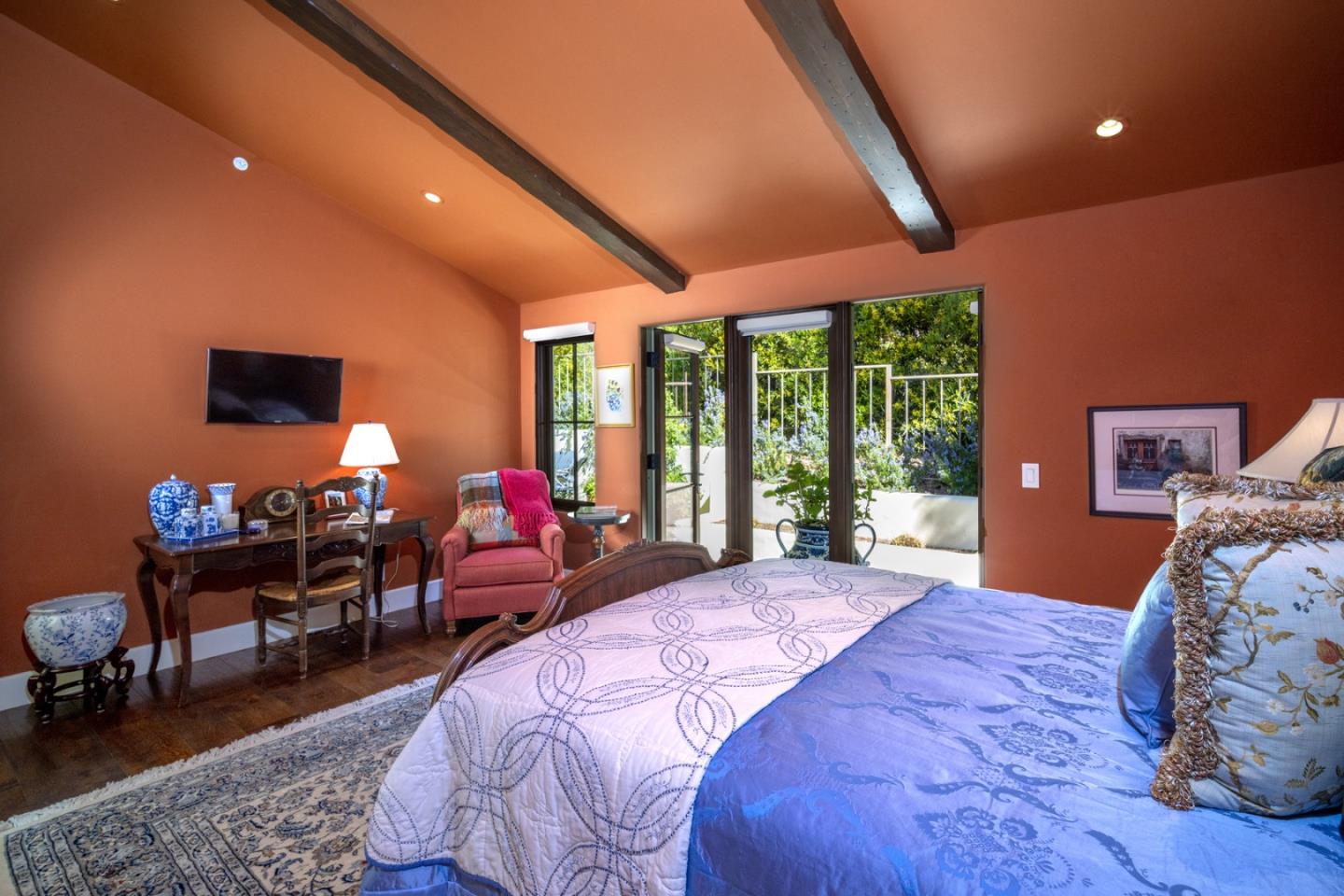 1565 Riata Road Pebble Beach, CA 93953 - Photo 14 of 23 a bedroom with a bed and large windows