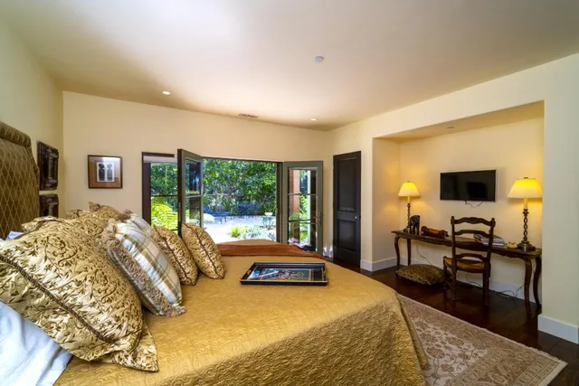 a bed room with a bed and a television