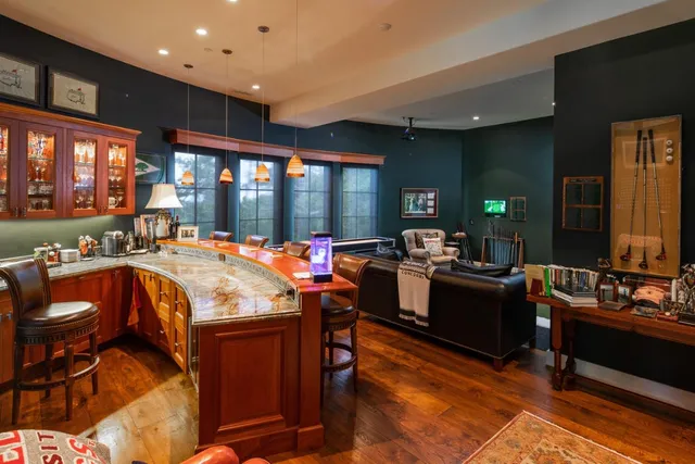 a large dining space with furniture and chandelier