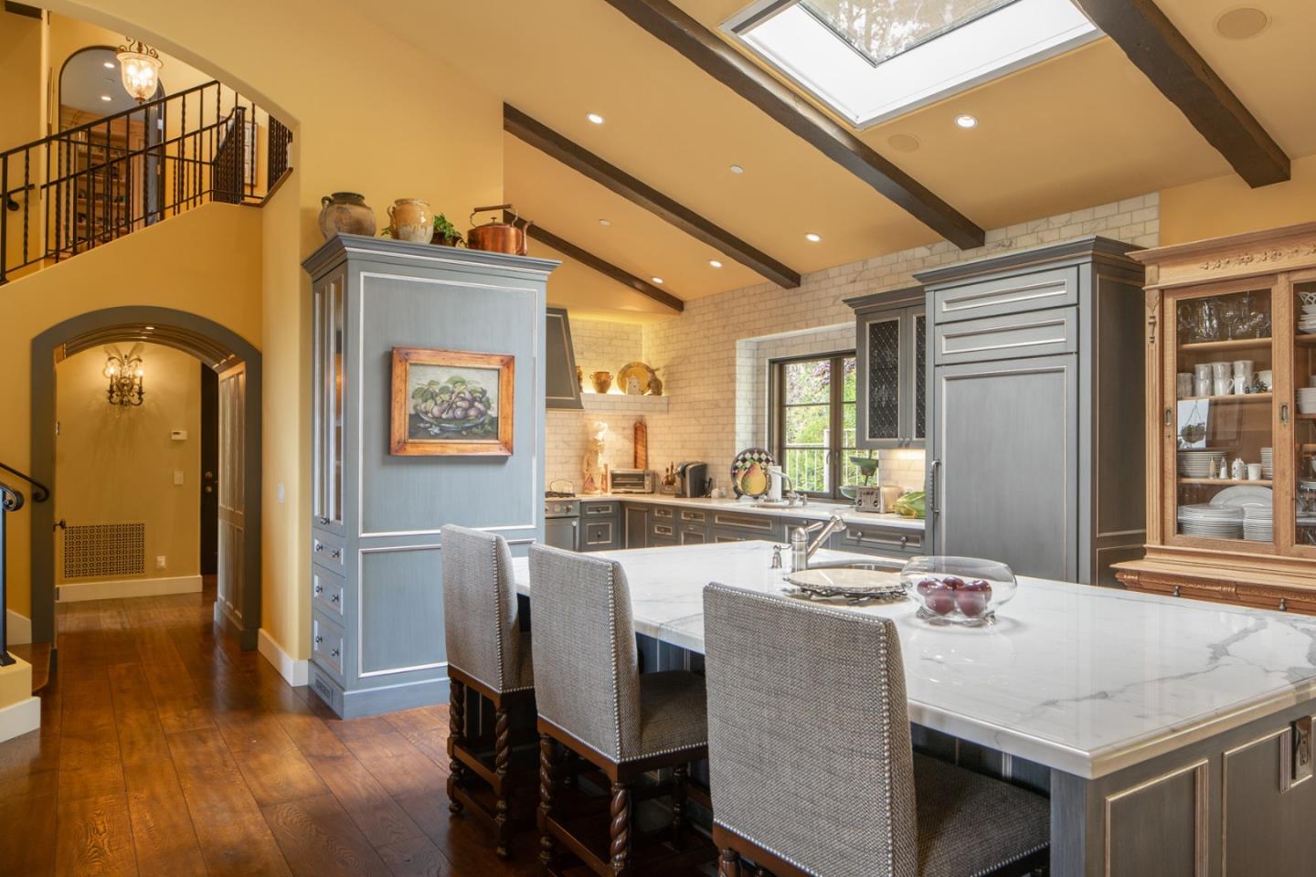 1565 Riata Road Pebble Beach, CA 93953 - Photo 10 of 23 a dining hall with stainless steel appliances granite countertop a dining table and chairs with wooden floor