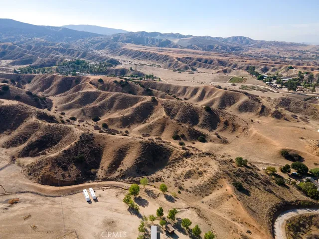 an aerial view of mountain with yard