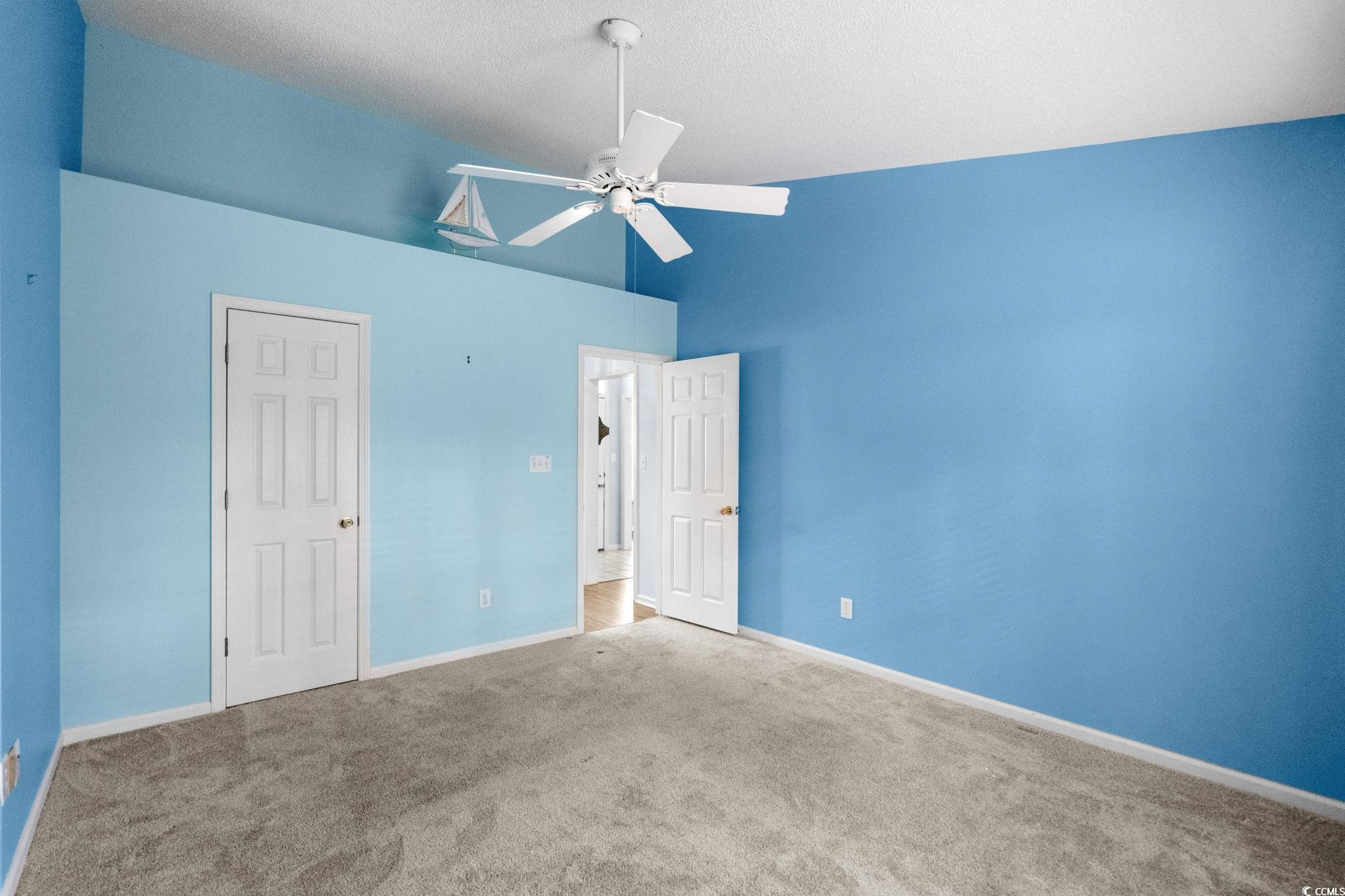 9568 Indigo Club Drive Murrells Inlet, SC 29576 - Photo 27 of 40 Unfurnished bedroom with carpet floors, a ceiling fan, and vaulted ceiling
