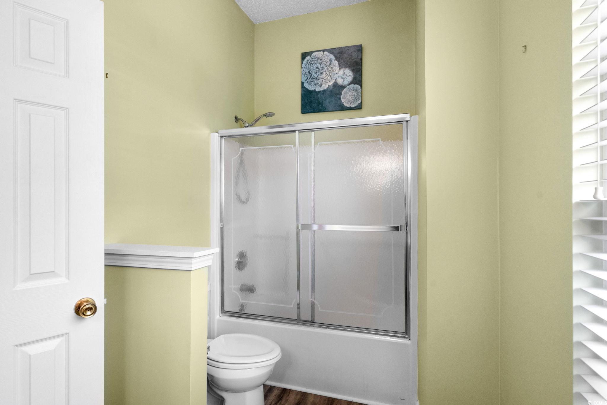 9568 Indigo Club Drive Murrells Inlet, SC 29576 - Photo 29 of 40 Full bathroom with combined bath / shower with glass door and dark wood finished floors