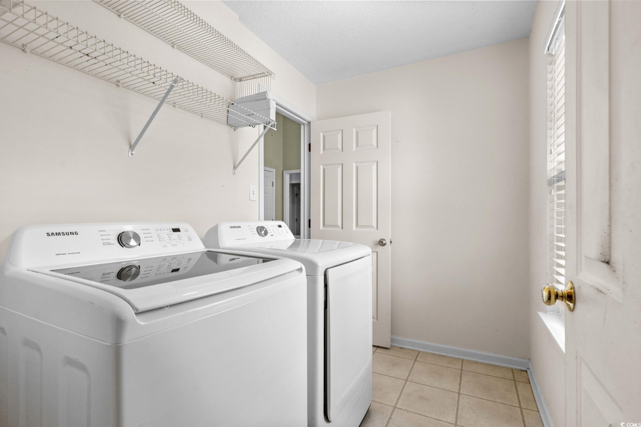 9568 Indigo Club Drive Murrells Inlet, SC 29576 - Photo 30 of 40 Laundry area featuring light tile patterned floors and independent washer and dryer