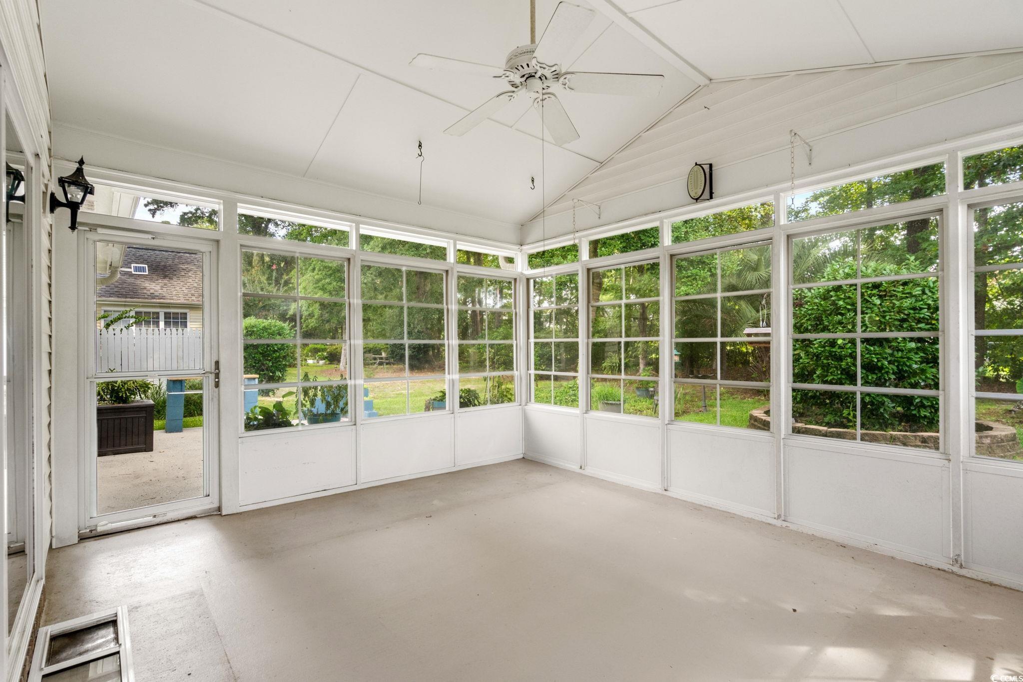 9568 Indigo Club Drive Murrells Inlet, SC 29576 - Photo 32 of 40 Unfurnished sunroom featuring vaulted ceiling and a ceiling fan