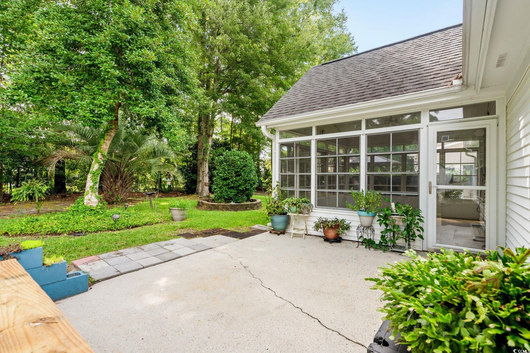 9568 Indigo Club Drive Murrells Inlet, SC 29576 - Photo 34 of 40 View of patio with a sunroom